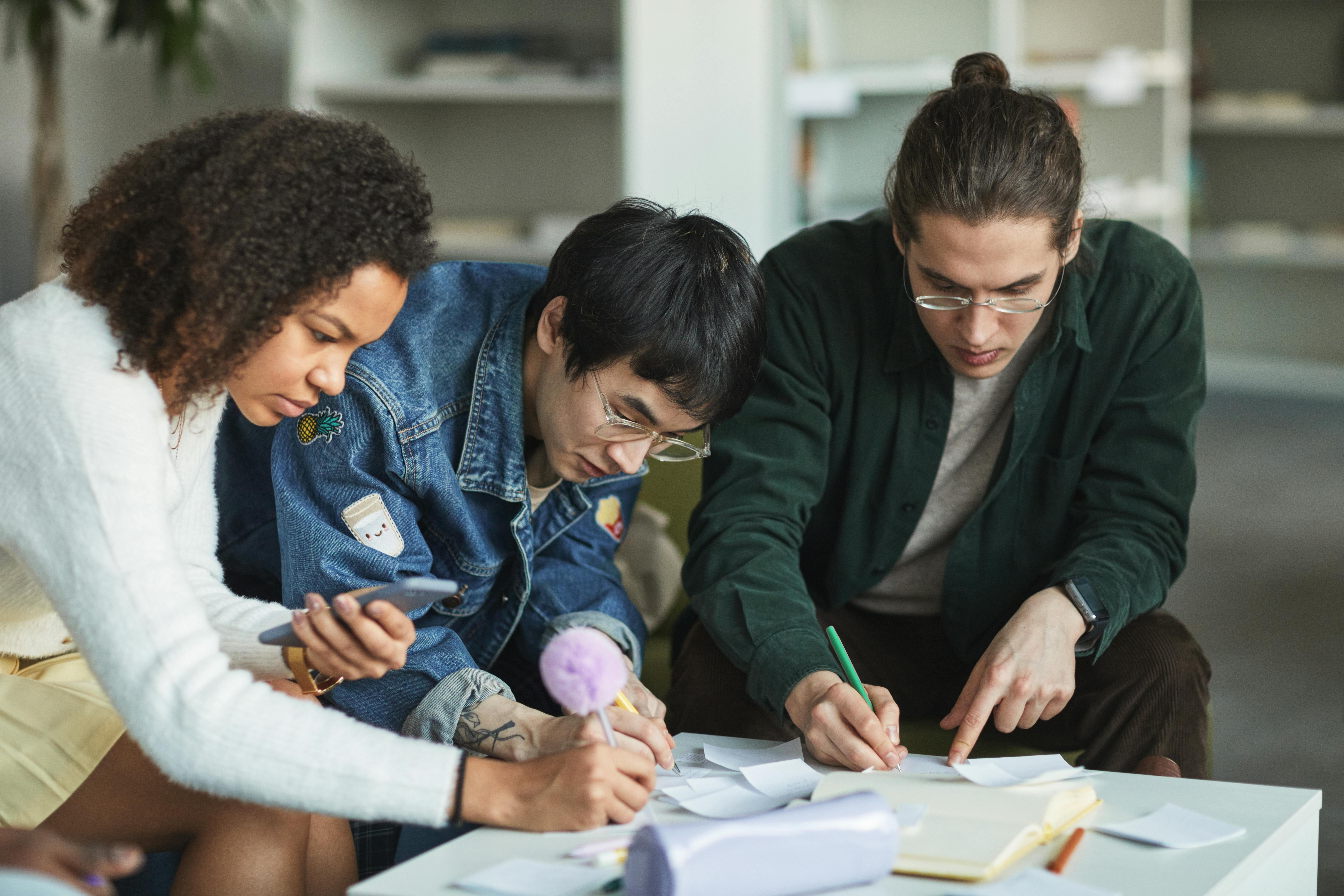 a group of people looking at papers