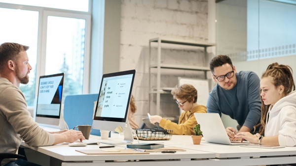 a group of people working on computers
