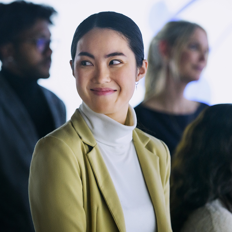 a person in a white turtleneck and a yellow jacket