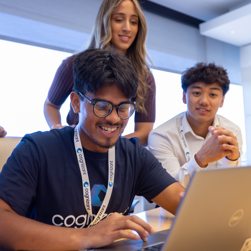 a group of people looking at a laptop