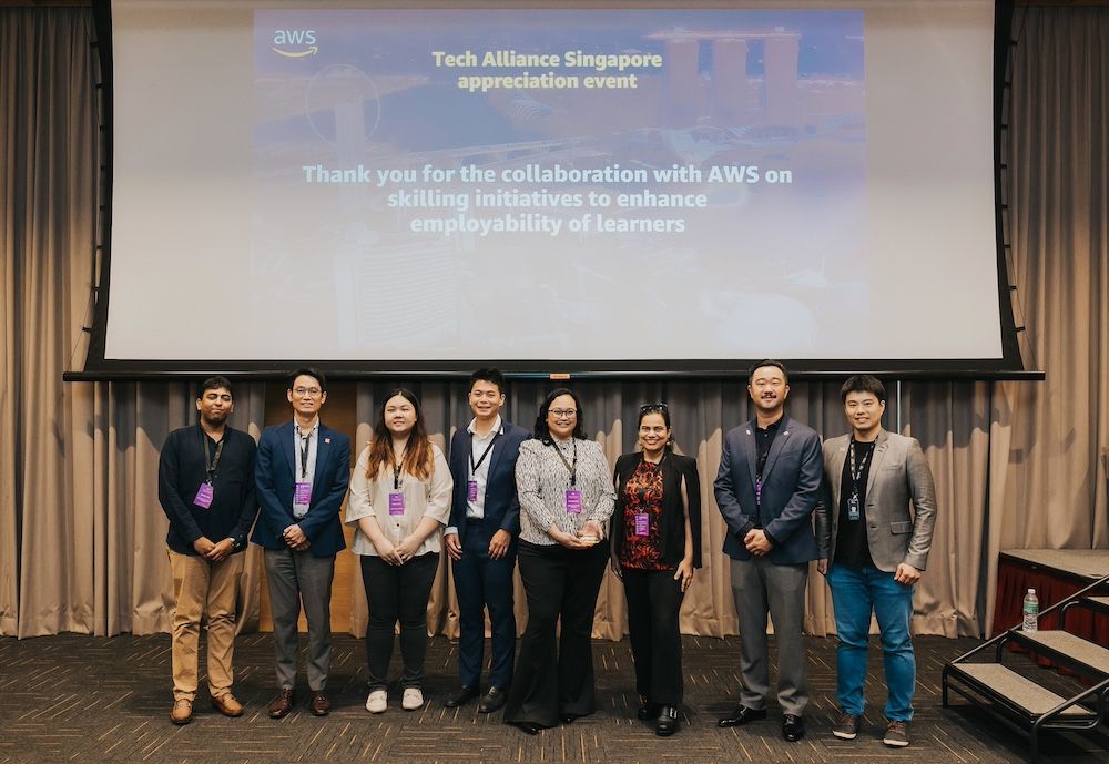 a group of people standing in front of a projector screen