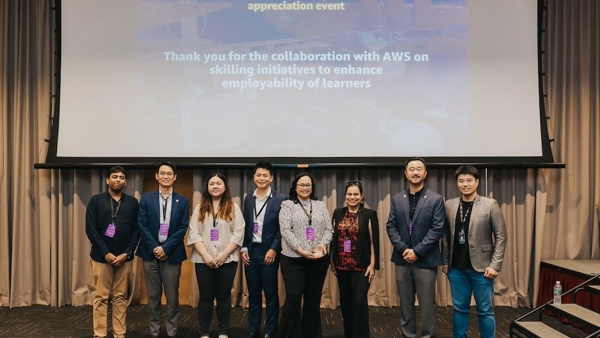 a group of people standing in front of a projector screen