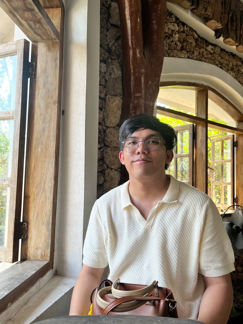 a person wearing glasses and a white shirt