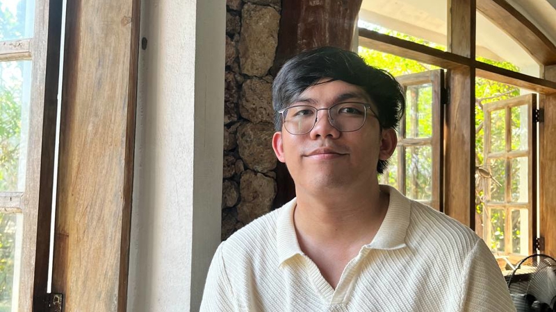a person wearing glasses and a white shirt