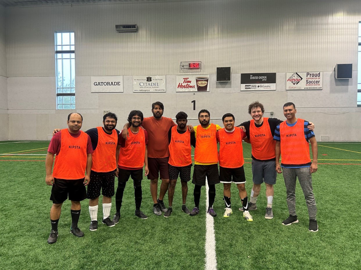 a group of men in orange shirts