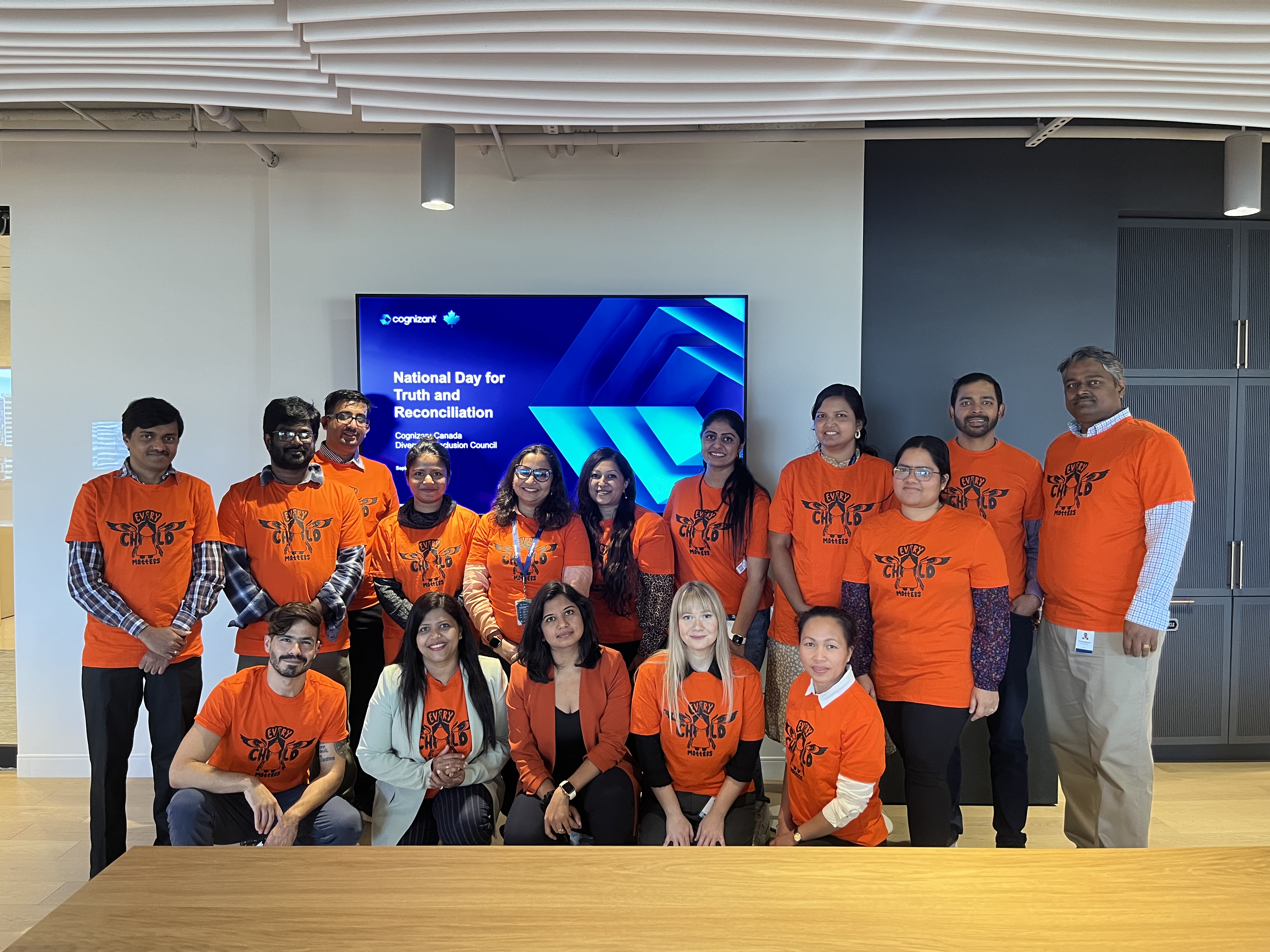 a group of people in orange shirts
