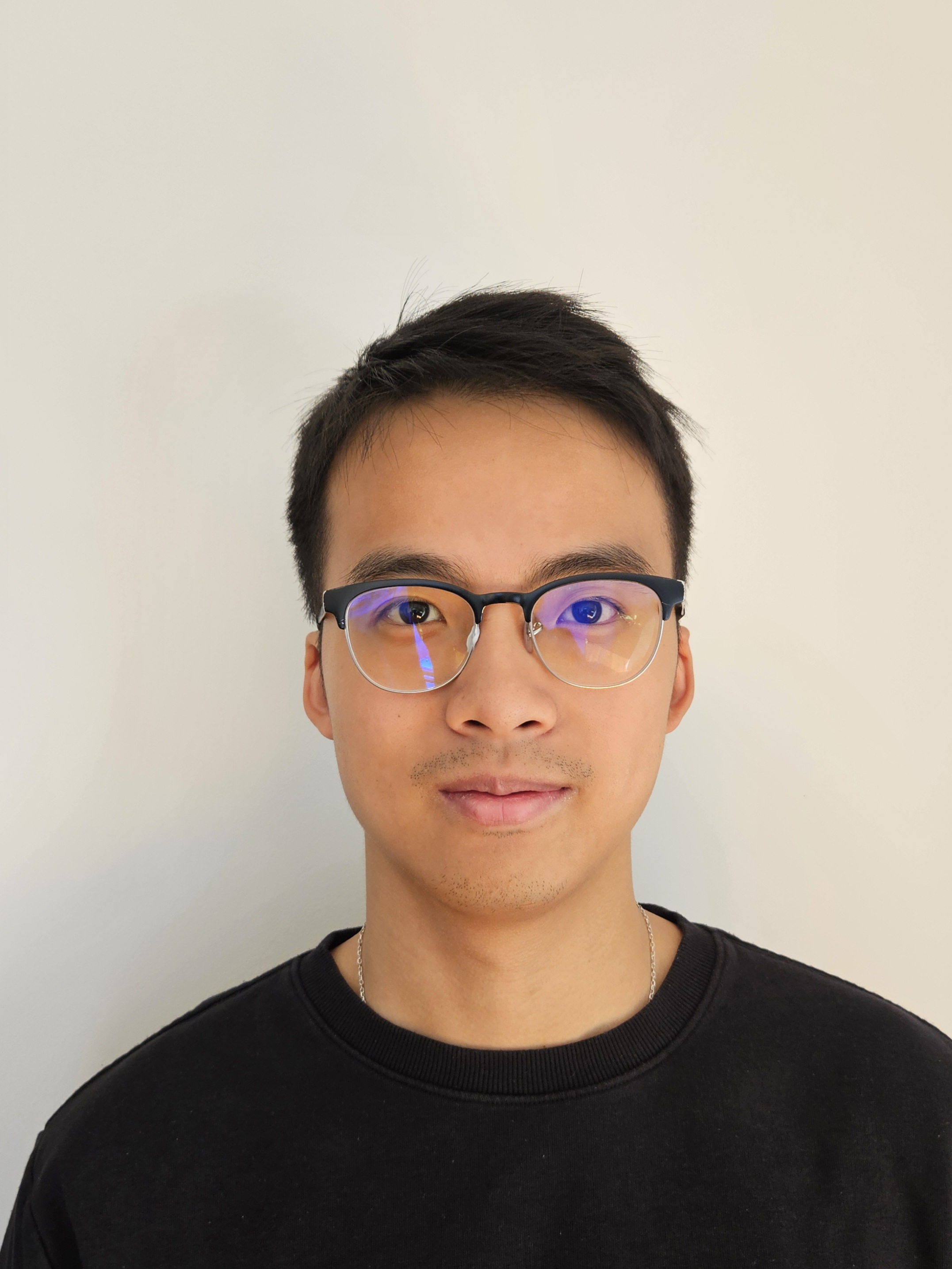 a person wearing glasses and smiling