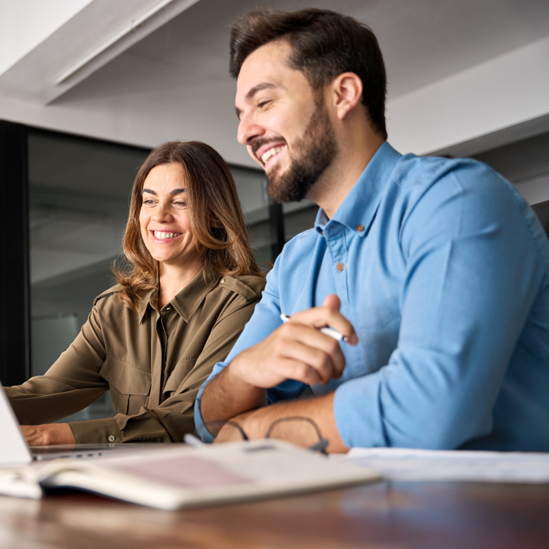 a person and person looking at a laptop