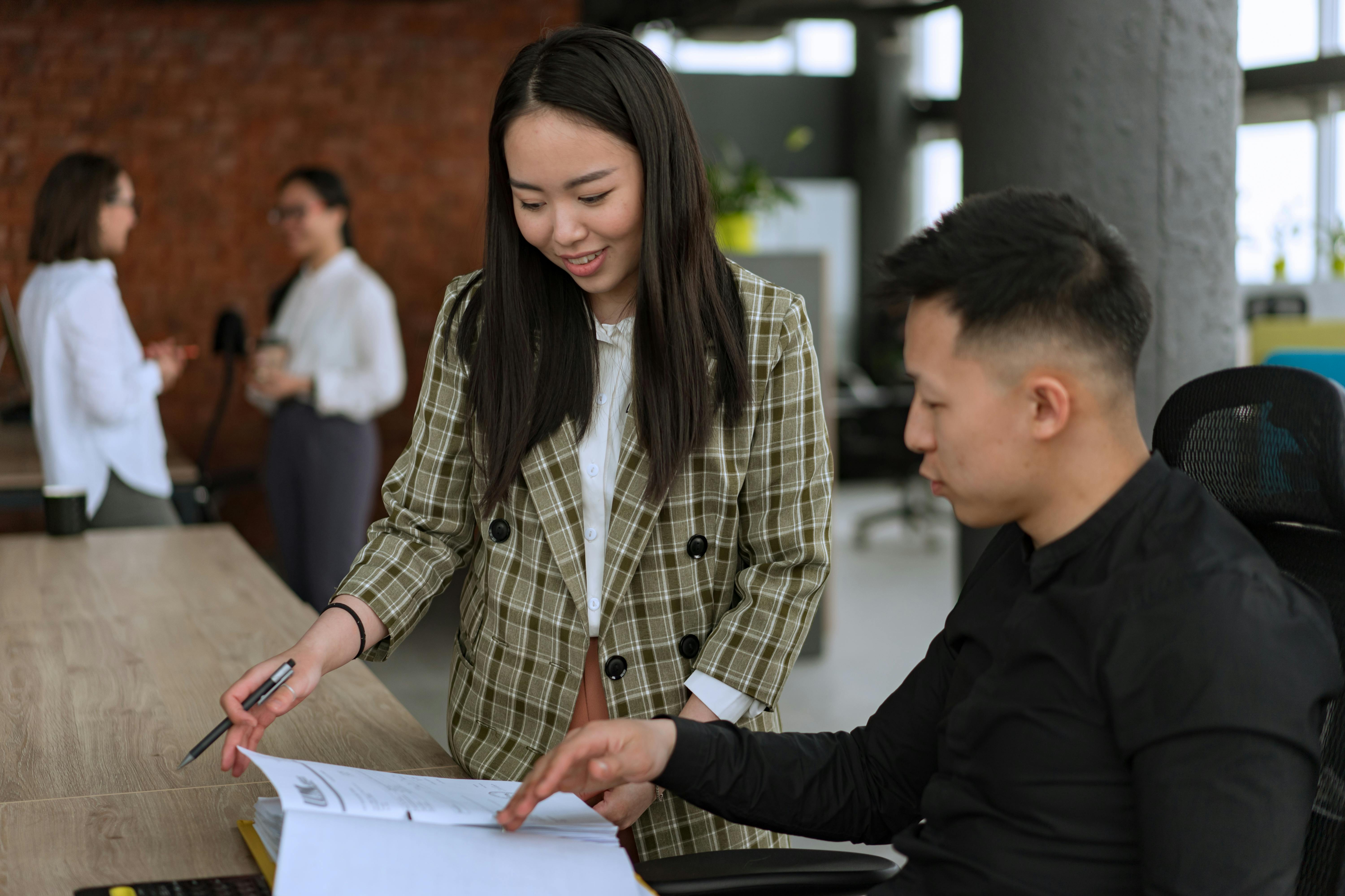 a person pointing at a piece of paper