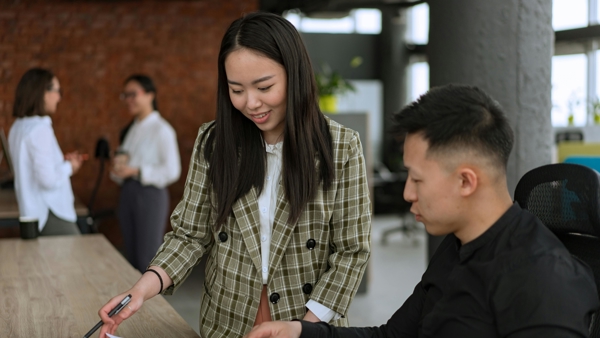 a person pointing at a piece of paper