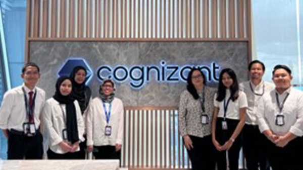 a group of people standing in front of a sign