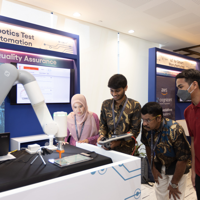 a group of people standing next to a machine