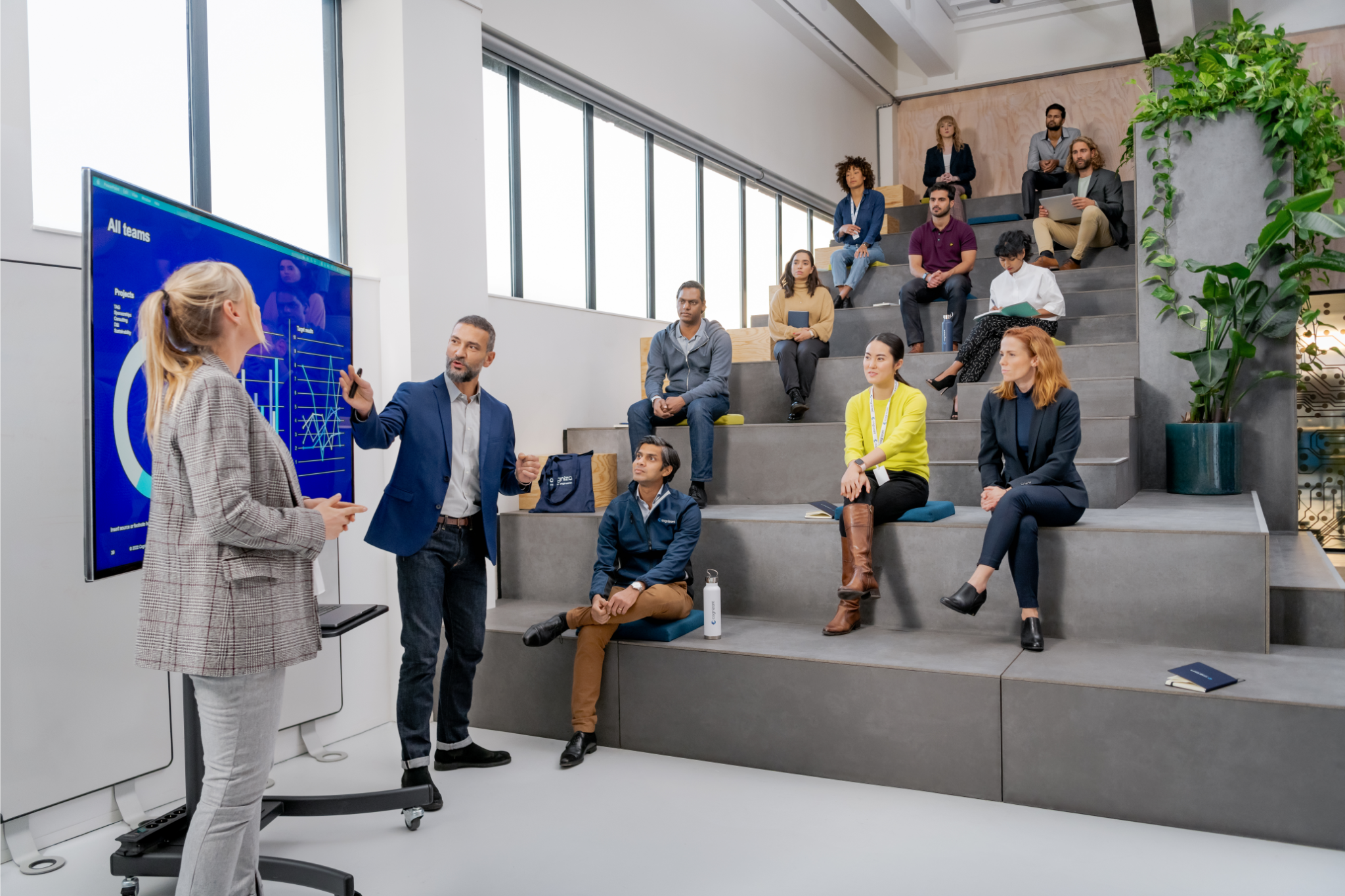 a person standing in front of a person standing in front of a group of people sitting on stairs