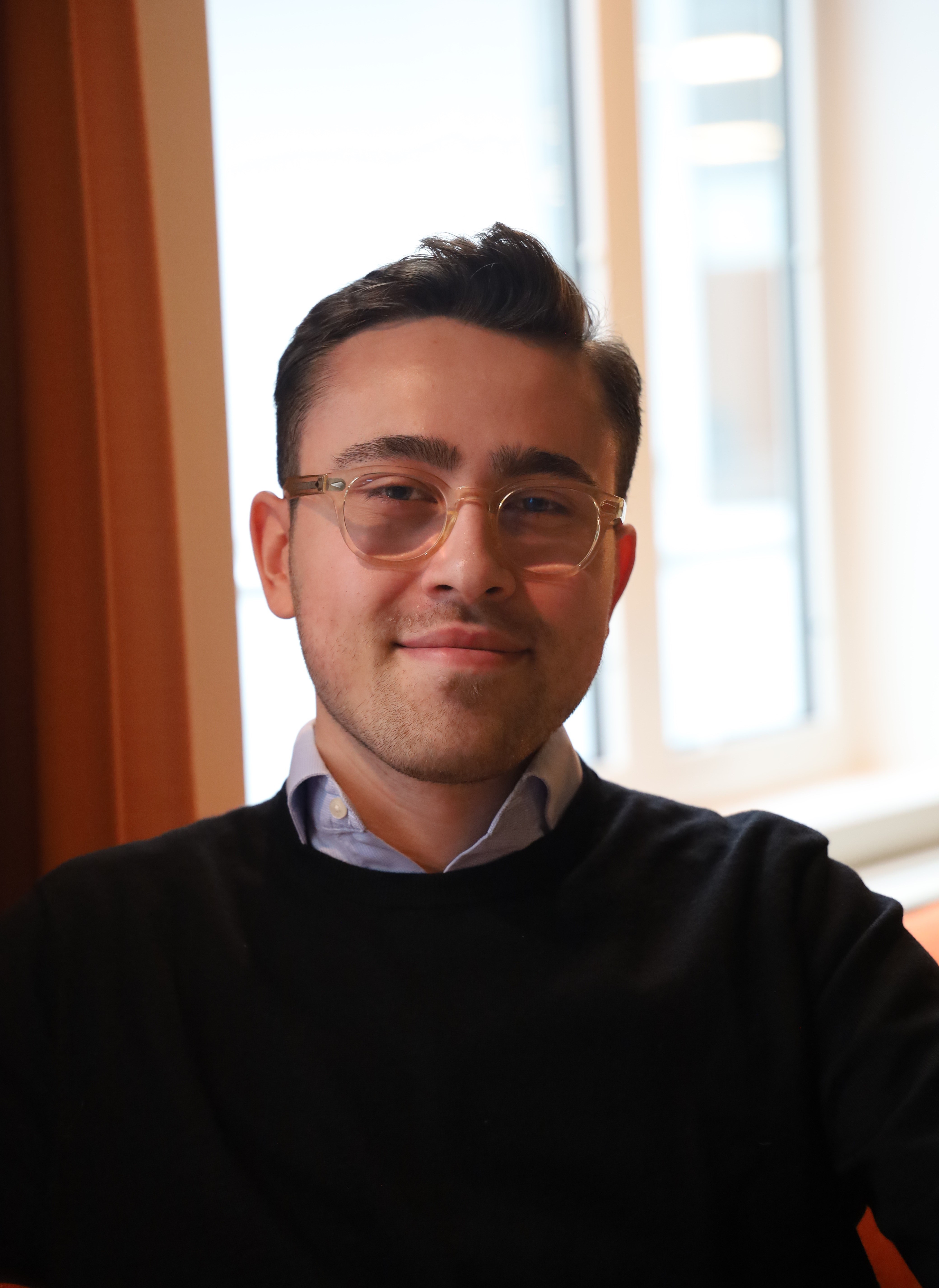 a person wearing glasses and a black shirt