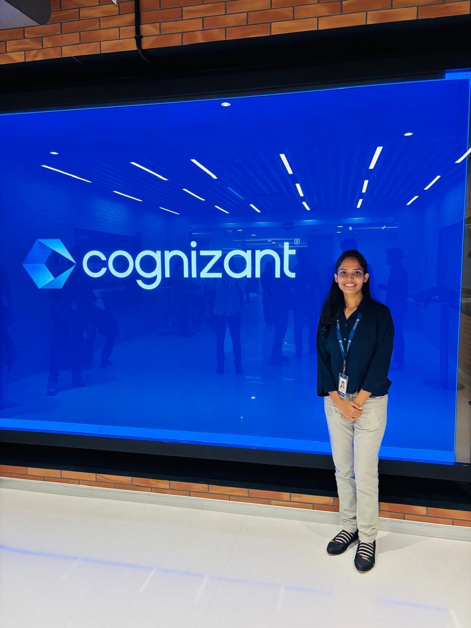 a person standing in front of a large blue sign