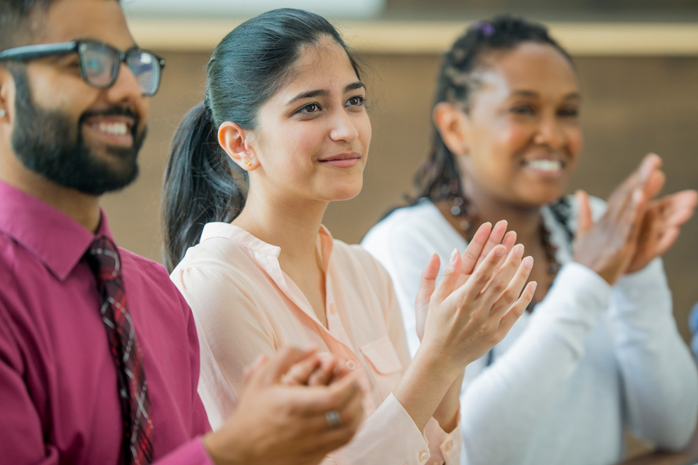 a group of people clapping
