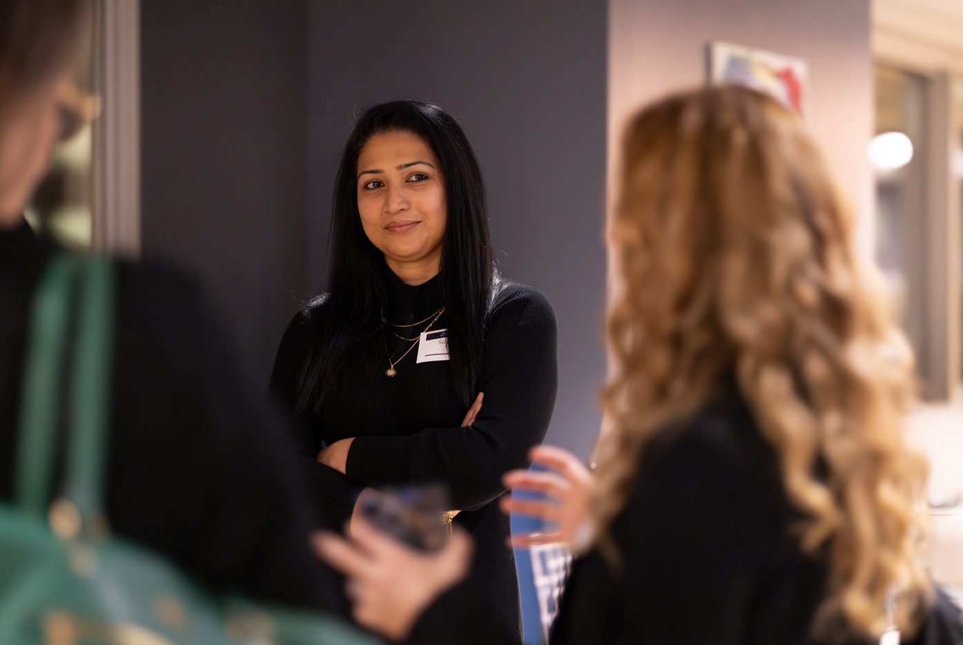 a person standing in front of a group of women