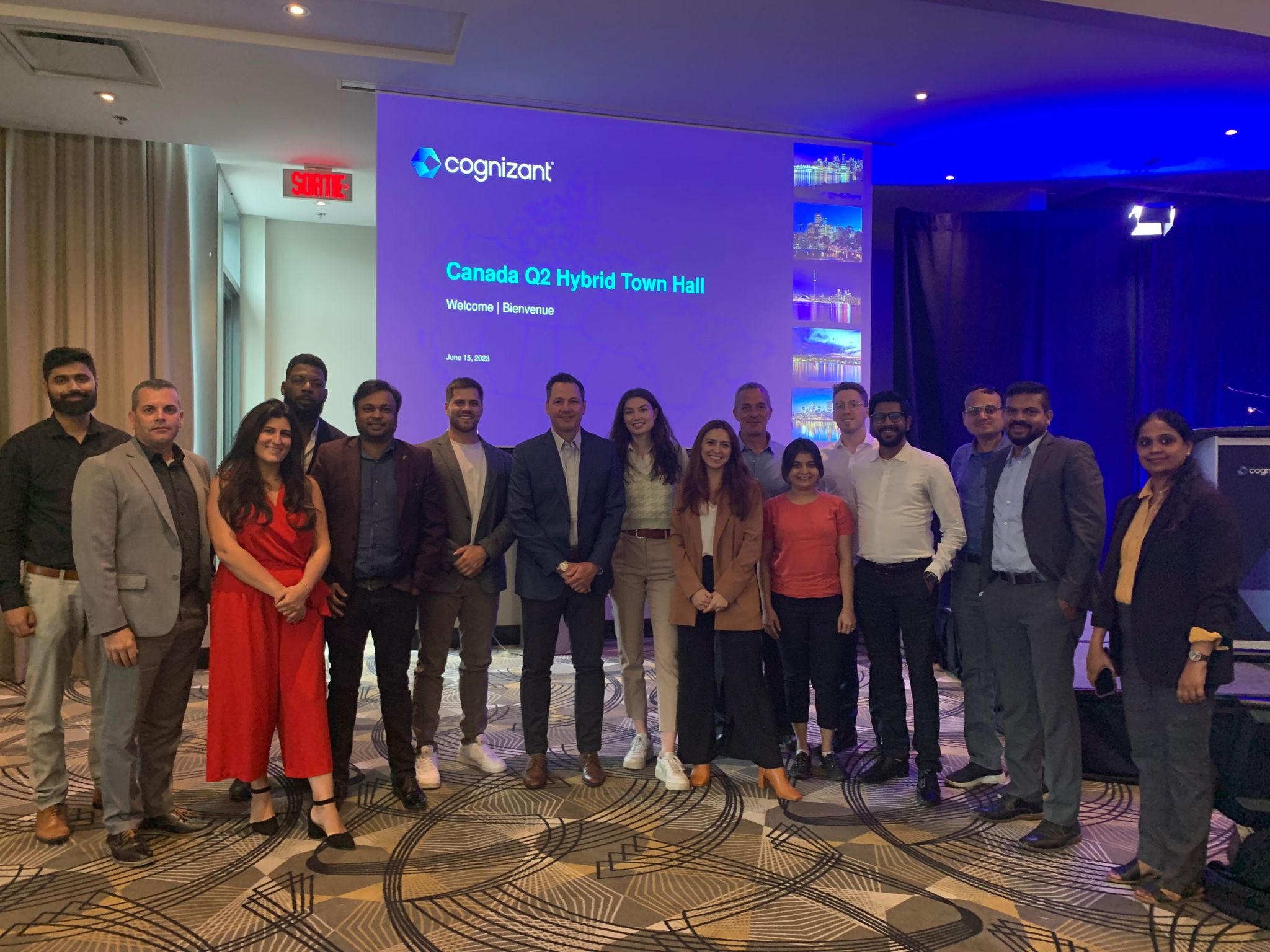 a group of people standing in front of a projector screen
