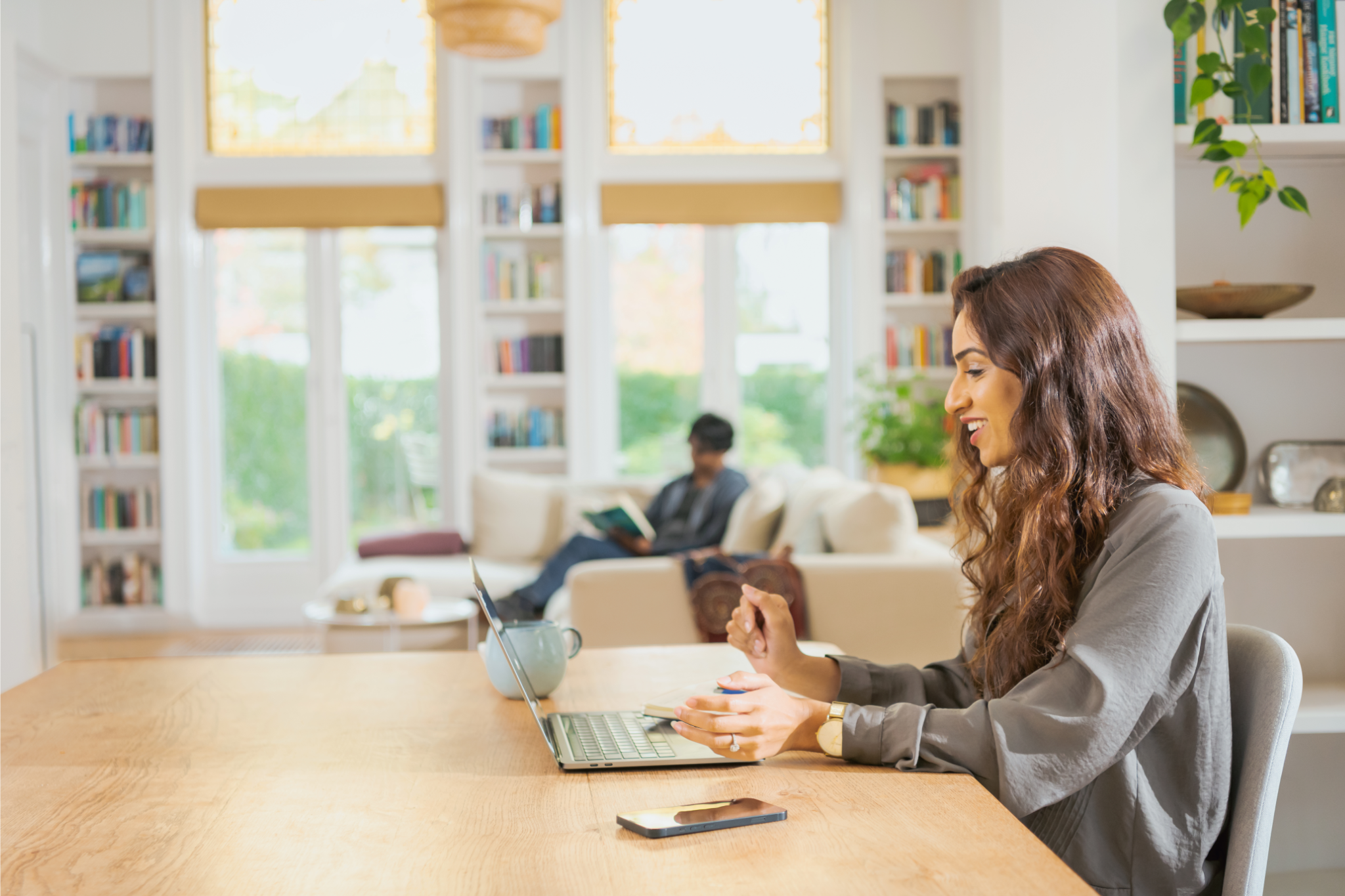 a person sitting at a table with a laptop