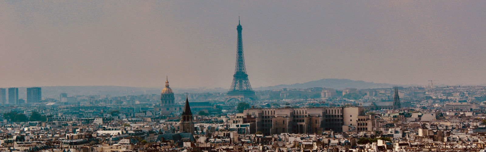 a city with a tall tower in the distance