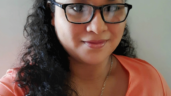 una persona con gafas y una camisa coral