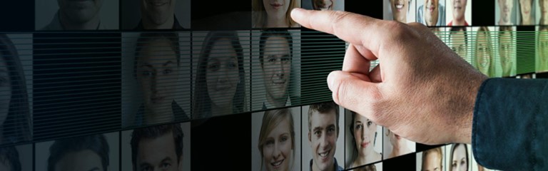 a finger pointing at a screen
