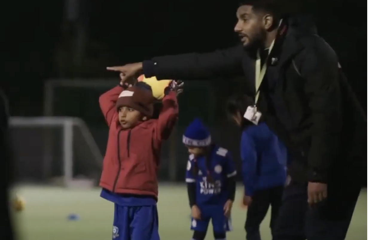 a person pointing at a child's head